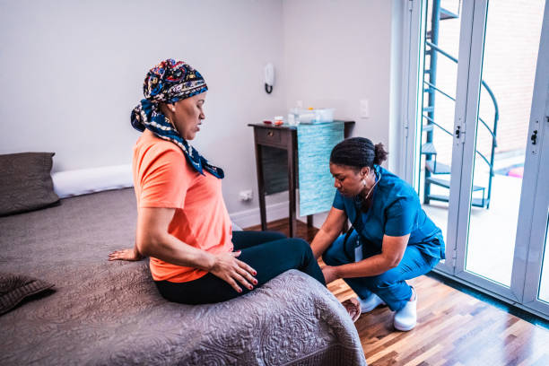 Caregiver assisting a client seated at the edge of the bed
